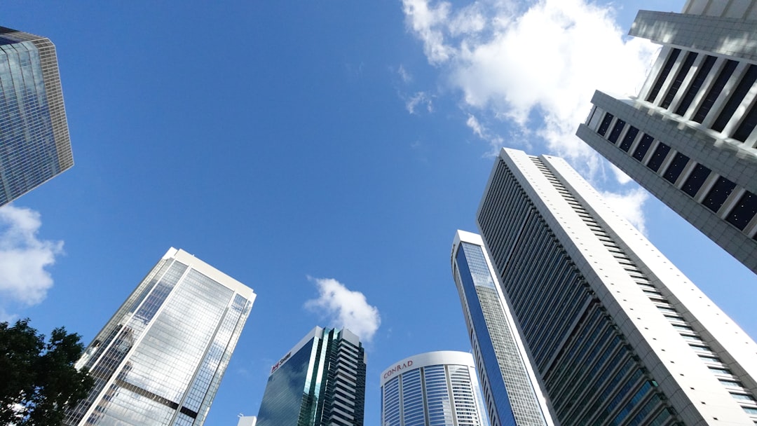 Modern skyscrapers reaching towards a clear blue sky.