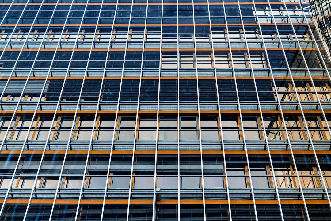 Modern building facade with repeating windows and blinds