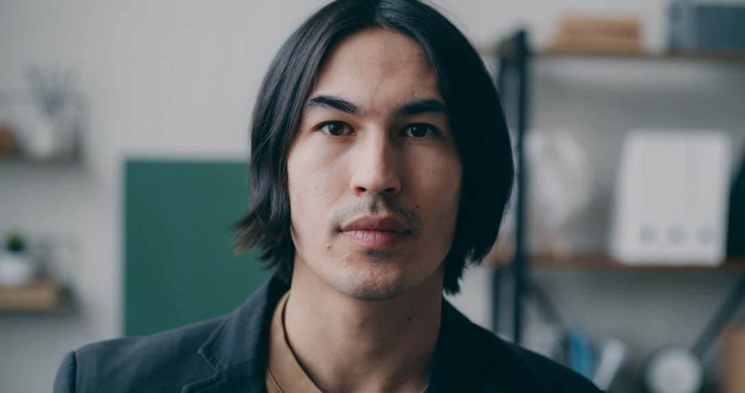 A man with long hair wearing a black jacket