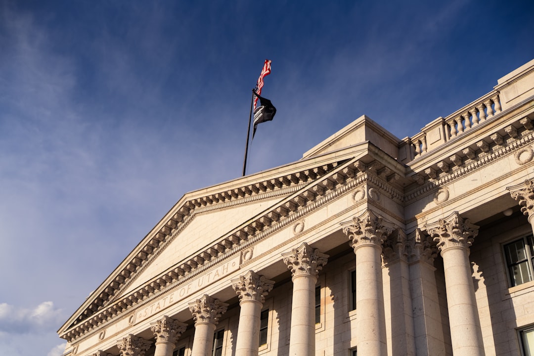 Neoclassical building with columns under a blue sky.