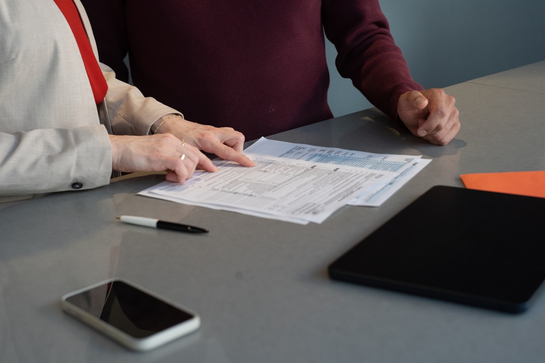 Two people reviewing documents at a table.